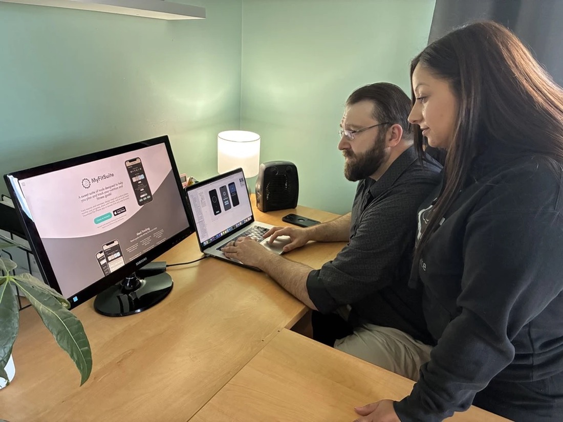 Brad Pineau and his wife Zoe working on an early version of Fitly AI, featured in SaltWire